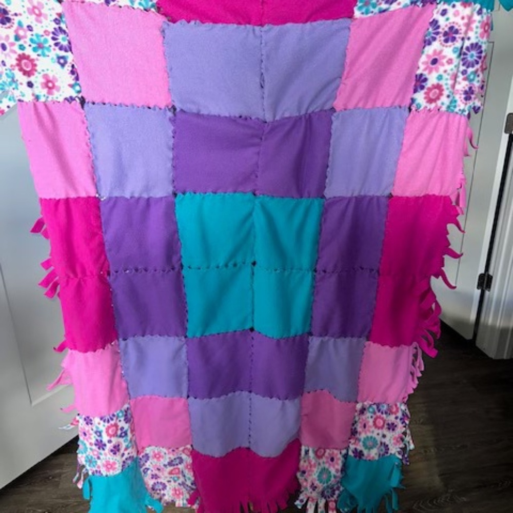 Fleece tie patchwork quilt throw blanket. Approximately 48" x 63"